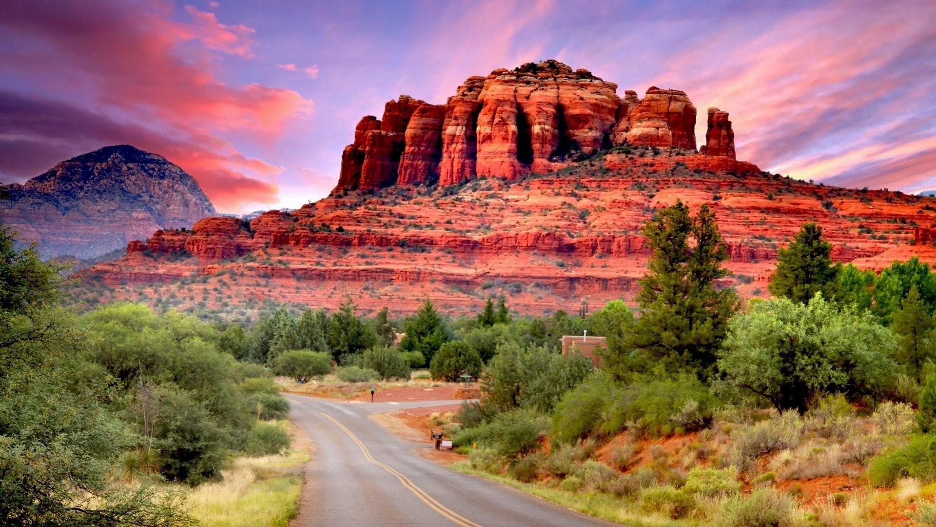 Sedona’s red rocks beneath a pink and violet sunset